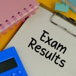 EXAM RESULT on white pad with exam tools on yellow background